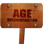 age discrimination text on wooden sign