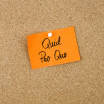 QUID PRO QUO written on orange sticky note QUID PRO QUO written on orange sticky note