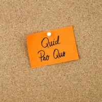 QUID PRO QUO written on orange sticky note