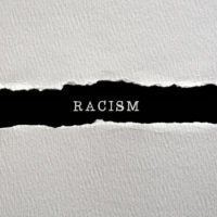 Racism written on torn paper