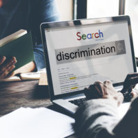 Lap top that reads discrimination.jpg.crdownload Lap top that reads discrimination.jpg.crdownload