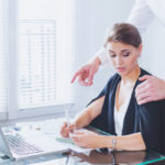 Manager touching employee on shoulder Manager touching employee on shoulder