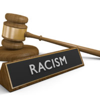 Racisim sign with gavel Racisim sign with gavel