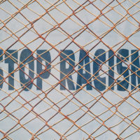 Fence that has stop racism sign