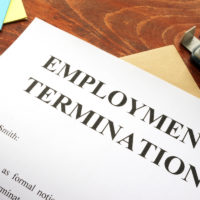 Employment termination letter on desk with office supplies