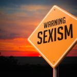 warning sexism Road Sign against sunset