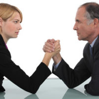 old man and young woman arm wrestling old man and young woman arm wrestling