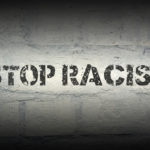 stop racism stencil print on brick wall stop racism stencil print on brick wall