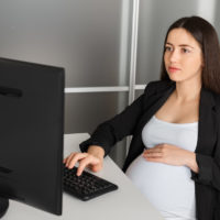 pregnant woman working in the office