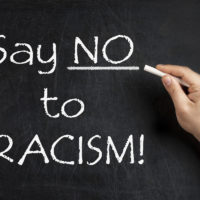 Say no to racism written with chalk on blackboard