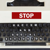 Retro typewriter with message stop racism and social exclusion message written on it Retro typewriter with message stop racism and social exclusion message written on it