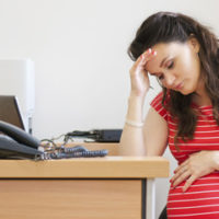 Picture of a sad pregnant employee Picture of a sad pregnant employee
