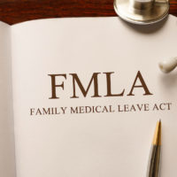 Page in FMLA book on the table with stethoscope and pencil on table