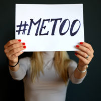 #metoo sign in front of blonde woman