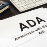 ADA documents, glasses, keyboard on desk