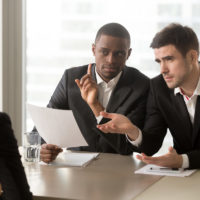 male recruiter doubting gestures toward female interviewee male recruiter doubting gestures toward female interviewee