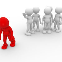 red figure walking away from group red figure walking away from group