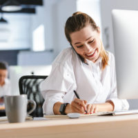 young employee on phone at her workspace