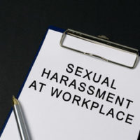 Clipboard that reads sexual harassment at workplace Clipboard that reads sexual harassment at workplace