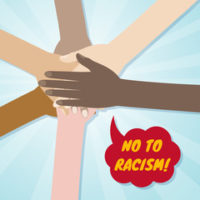 All hands with sign that reads no to racisim All hands with sign that reads no to racisim