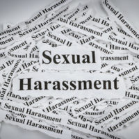 Pieces of paper that read sexual harassment Pieces of paper that read sexual harassment