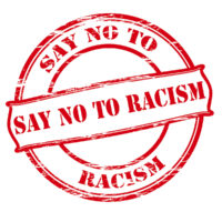 Say no to racism rubber stamped in red