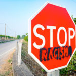 The sign thats on the street stop racism The sign thats on the street stop racism