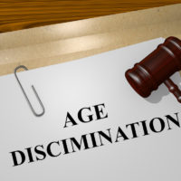 Age discrimination document with gavel on table