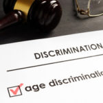 Sheet of paper that reads age discrimination Sheet of paper that reads age discrimination