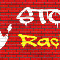 stop racism graffiti written over bricks and handprint stop racism graffiti written over bricks and handprint