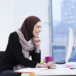 Beautiful Arabic business woman working on computer. Woman in her office Beautiful Arabic business woman working on computer. Woman in her office
