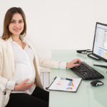 Pregnant Businesswoman Working In Office