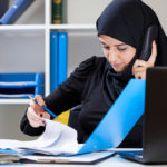 Muslim office worker on phone