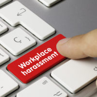 red key reads workplace harassment