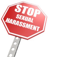stop sign that reads stop sexual harassment