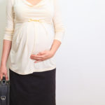 pregnant businesswoman getting ready to go to work