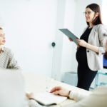 pregnant working woman with ipad in the office