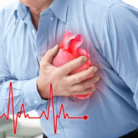 Man with chest pain suffering from heart attack in office