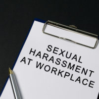 Sexual harassment at workplace word on paper