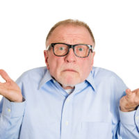 So what? I don't know. Clueless senior man shrugs his shoulders So what? I don't know. Clueless senior man shrugs his shoulders