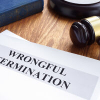 Wrongful termination. Documents and gavel on a desk.