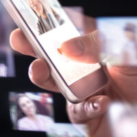 Online dating app or site in mobile phone. Finding love and romance from internet with smartphone. Man giving like. Many hologram photos of beautiful woman around cellphone. Stalker looking at profile Online dating app or site in mobile phone. Finding love and romance from internet with smartphone. Man giving like. Many hologram photos of beautiful woman around cellphone. Stalker looking at profile