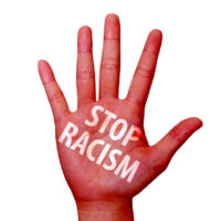 stop racism written on a hand