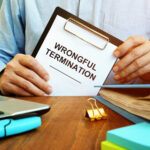 Employee holds papers about wrongful termination.