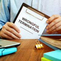 Employee holds papers about wrongful termination.