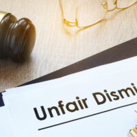 Documents unfair dismissal and gavel in a court.