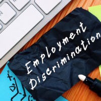 Employment Discrimination inscription on the piece of paper. Employment Discrimination inscription on the piece of paper.