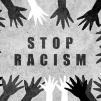 Hands of different colors and cultures of the world unite in a circle against racism. Design with a powerful anti-racism message. Hands of different colors and cultures of the world unite in a circle against racism. Design with a powerful anti-racism message.