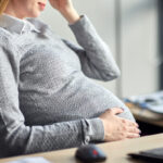 pregnant businesswoman sitting at office