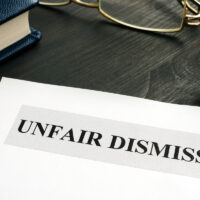 Unfair dismissal documents and pen in an office.